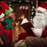 Mysterious santa claus reading a book with children